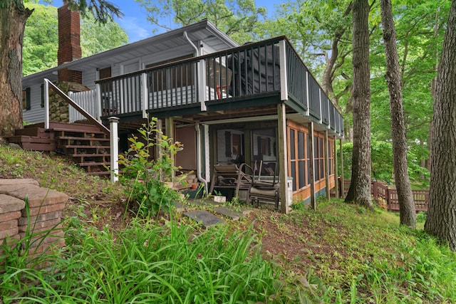3184 N Lakeshore Dr, Hillsdale, MI 49242 - rear view of property with a wooden deck, a sunroom, stairs, and a chimney