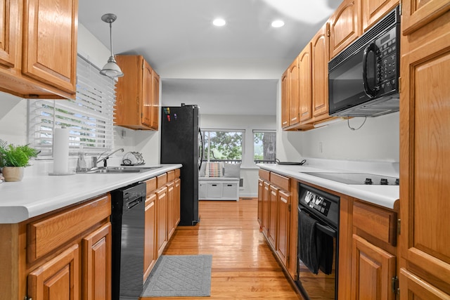3184 N Lakeshore Dr, Hillsdale, MI 49242 - kitchen with black appliances, light wood finished floors, pendant lighting, light countertops, and recessed lighting