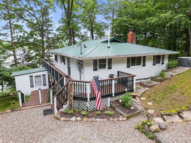 3184 N Lakeshore Dr, Hillsdale, MI 49242 - back of house featuring a wooden deck, a chimney, and a metal roof