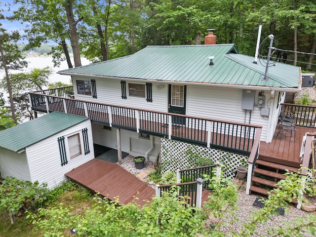 3184 N Lakeshore Dr, Hillsdale, MI 49242 - rear view of property with a deck, a metal roof, and a chimney