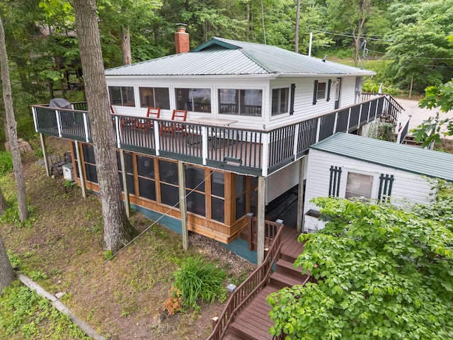 3184 N Lakeshore Dr, Hillsdale, MI 49242 - back of house featuring stairs, a chimney, a deck, and a metal roof