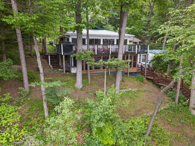 3184 N Lakeshore Dr, Hillsdale, MI 49242 - rear view of property featuring stairs, a wooden deck, and a metal roof