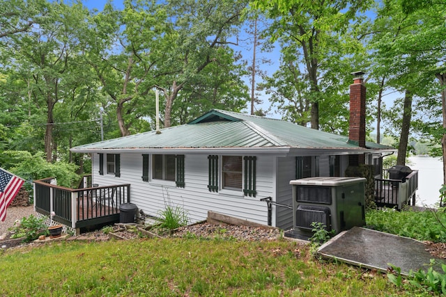 3184 N Lakeshore Dr, Hillsdale, MI 49242 - view of front of property featuring a chimney, a wooden deck, and a metal roof