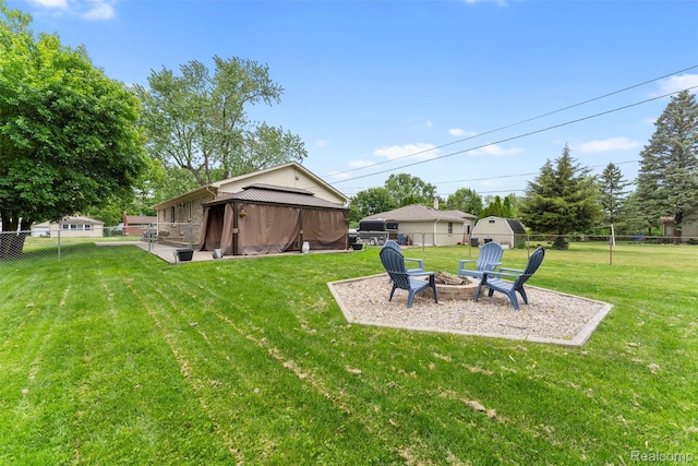 4981 Harding St, Dearborn Heights, MI 48125 - fenced backyard with a fire pit, a gazebo, and a patio area