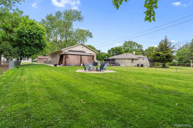 4981 Harding St, Dearborn Heights, MI 48125 - fenced backyard with a fire pit and a gazebo