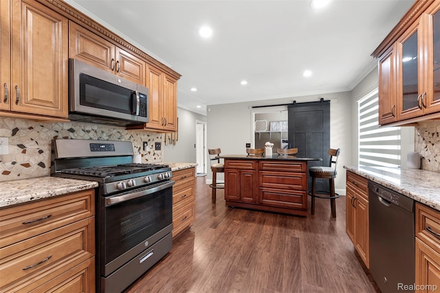 4981 Harding St, Dearborn Heights, MI 48125 - kitchen featuring stainless steel appliances, a barn door, dark wood-style floors, backsplash, and recessed lighting