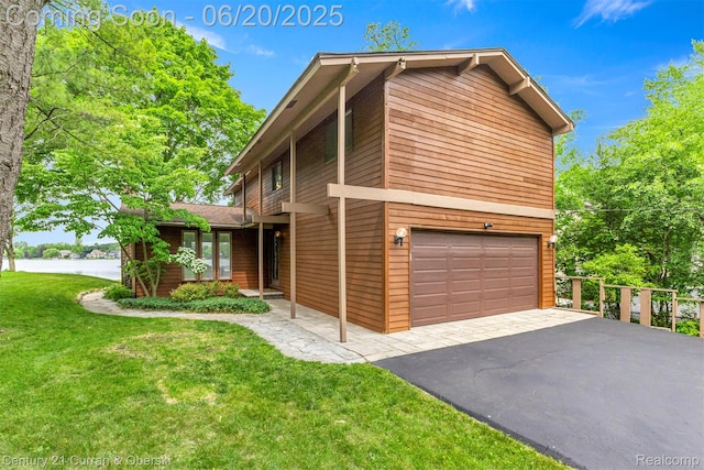 3150 Wellington Ct, West Bloomfield, MI 48324 - view of front of property featuring a garage, a front lawn, a water view, and asphalt driveway