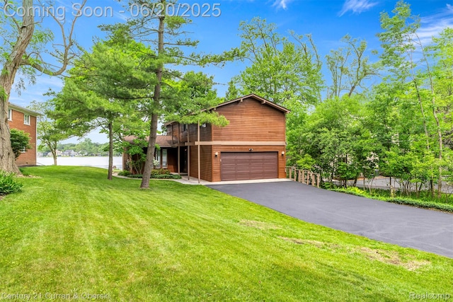 3150 Wellington Ct, West Bloomfield, MI 48324 - chalet / cabin featuring a water view, driveway, and a garage