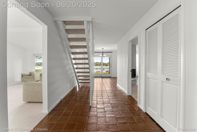 3150 Wellington Ct, West Bloomfield, MI 48324 - hall featuring a chandelier and stairs