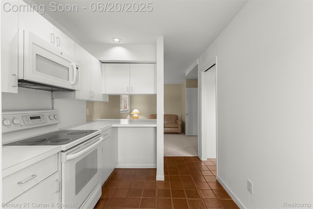 3150 Wellington Ct, West Bloomfield, MI 48324 - kitchen with white appliances, dark tile patterned flooring, light countertops, and white cabinetry