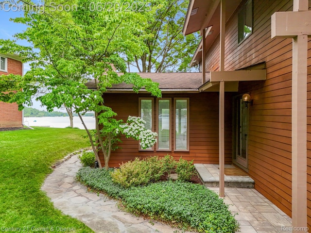 3150 Wellington Ct, West Bloomfield, MI 48324 - entrance to property with a lawn, a water view, and roof with shingles