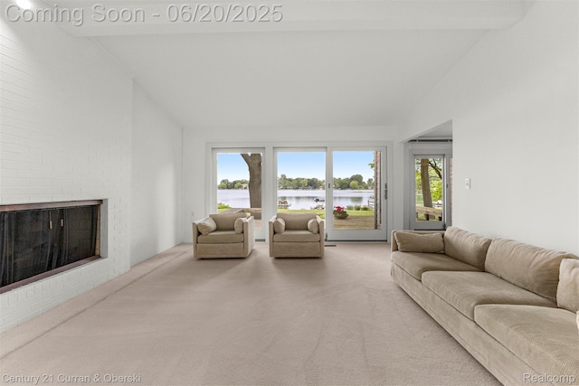 3150 Wellington Ct, West Bloomfield, MI 48324 - living area with carpet flooring, high vaulted ceiling, a water view, and a brick fireplace