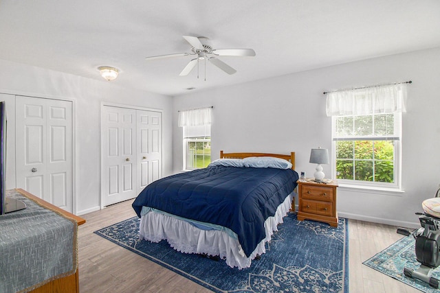 749 W Barrington Cir, Jackson, MI 49203 - bedroom featuring multiple closets, wood finished floors, and ceiling fan