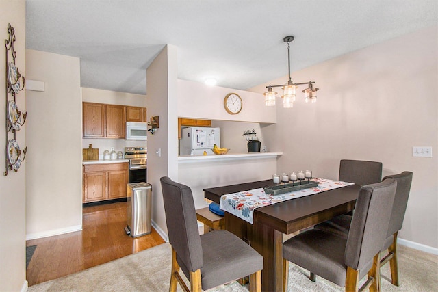 749 W Barrington Cir, Jackson, MI 49203 - dining area featuring baseboards and light wood-style flooring