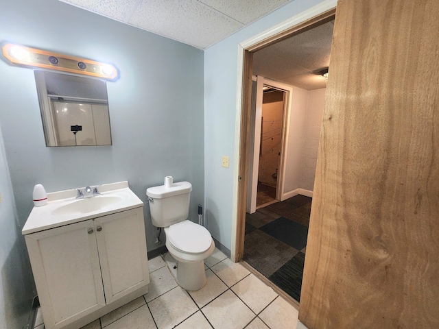 254 Holly St SW, Grand Rapids, MI 49548 - bathroom with vanity, a paneled ceiling, and tile patterned flooring