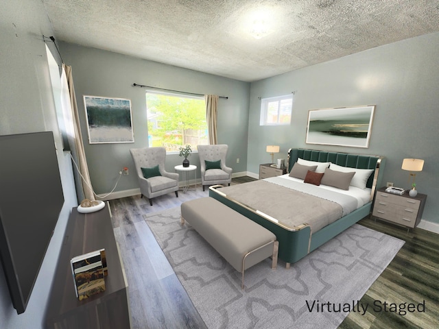 254 Holly St SW, Grand Rapids, MI 49548 - bedroom featuring wood finished floors and a textured ceiling