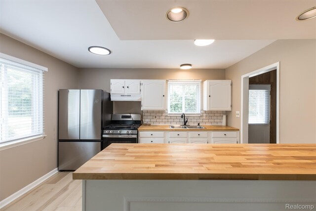 6580 Troy St, Southgate, MI 48180 - kitchen featuring butcher block counters, stainless steel appliances, under cabinet range hood, white cabinets, and recessed lighting