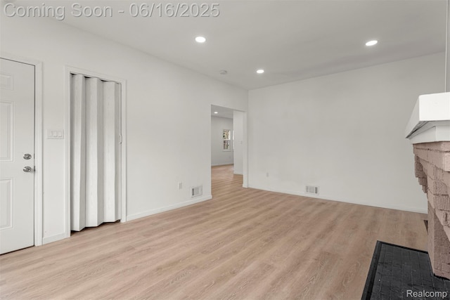 7432 Churchill St, Detroit, MI 48206 - unfurnished living room with light wood-type flooring, recessed lighting, and a fireplace