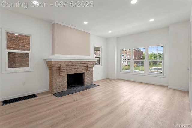 7432 Churchill St, Detroit, MI 48206 - unfurnished living room with recessed lighting, light wood-type flooring, and a fireplace