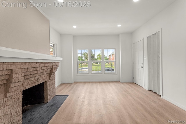 7432 Churchill St, Detroit, MI 48206 - unfurnished living room with wood finished floors, a brick fireplace, and recessed lighting