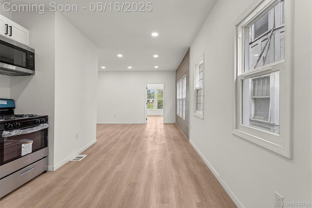 7432 Churchill St, Detroit, MI 48206 - kitchen with appliances with stainless steel finishes, light wood-style floors, recessed lighting, and white cabinets