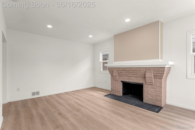 7432 Churchill St, Detroit, MI 48206 - unfurnished living room with wood finished floors, recessed lighting, and a brick fireplace