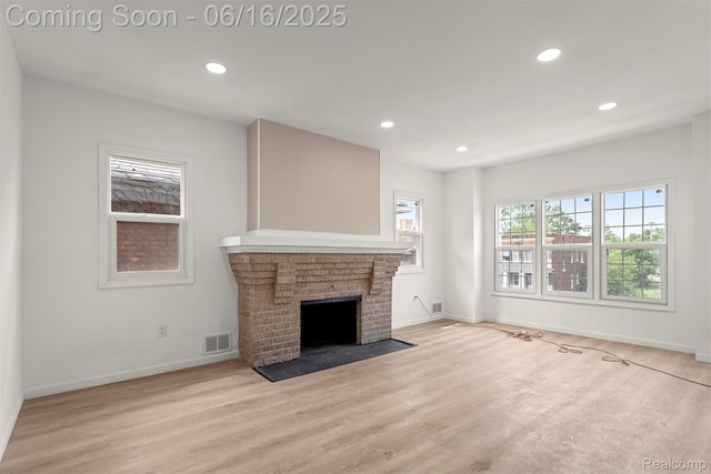 7432 Churchill St, Detroit, MI 48206 - unfurnished living room featuring recessed lighting, light wood-style flooring, and a brick fireplace