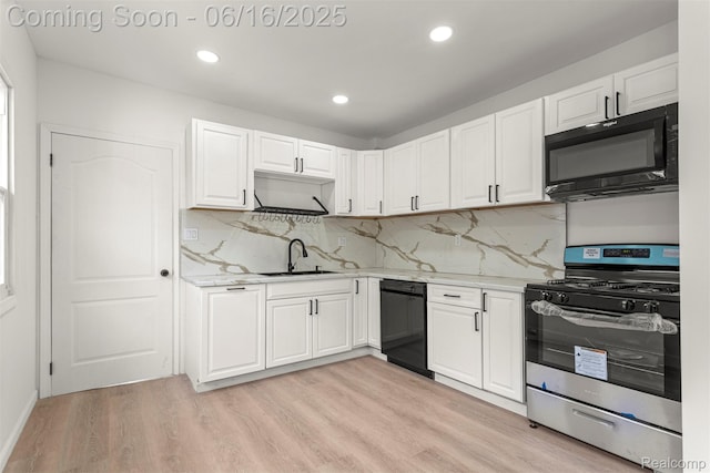 7432 Churchill St, Detroit, MI 48206 - kitchen with black appliances, light wood-style flooring, white cabinetry, recessed lighting, and backsplash