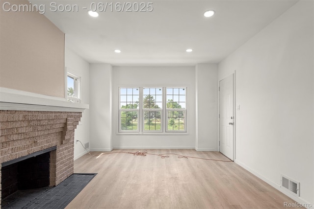 7432 Churchill St, Detroit, MI 48206 - unfurnished living room with wood finished floors, plenty of natural light, recessed lighting, and a fireplace