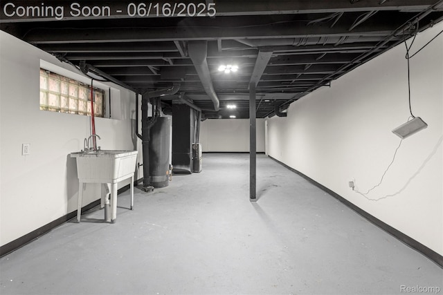 7432 Churchill St, Detroit, MI 48206 - below grade area with baseboards and water heater