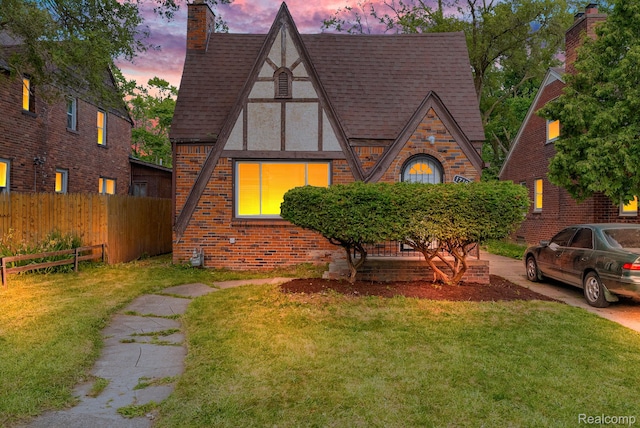 17196 Murray Hill St, Detroit, MI 48235 - tudor house featuring roof with shingles, stucco siding, a chimney, and brick siding