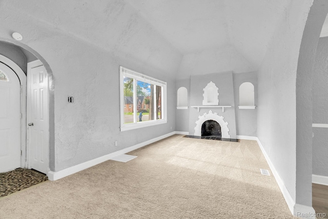 17196 Murray Hill St, Detroit, MI 48235 - unfurnished living room featuring carpet flooring, a textured wall, a fireplace, and lofted ceiling
