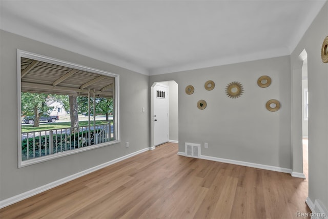 3112 Bailey Ave, Lincoln Park, MI 48146 - empty room with light wood-style floors and arched walkways