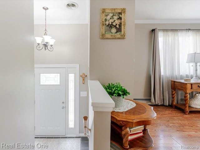 871 Vanderpool Dr, Troy, MI 48083 - entryway featuring a chandelier, crown molding, and wood finished floors