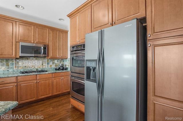 24825 Reeds Pointe Dr, Novi, MI 48374 - kitchen with appliances with stainless steel finishes, light stone countertops, backsplash, dark wood finished floors, and recessed lighting