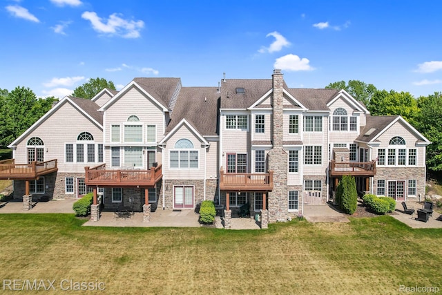 24825 Reeds Pointe Dr, Novi, MI 48374 - rear view of house featuring stone siding, a patio, and a lawn