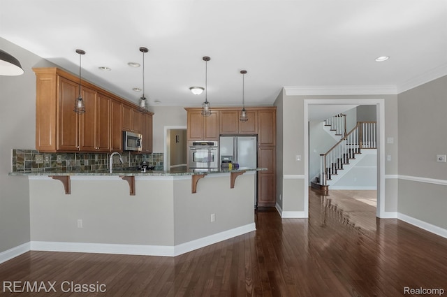 24825 Reeds Pointe Dr, Novi, MI 48374 - kitchen featuring stainless steel appliances, a kitchen bar, a peninsula, stone counters, and recessed lighting