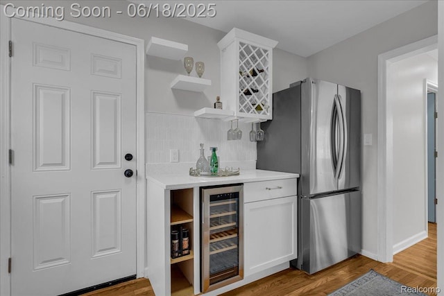 19505 Santa Barbara Dr, Detroit, MI 48221 - indoor dry bar featuring freestanding refrigerator, beverage cooler, and wood finished floors