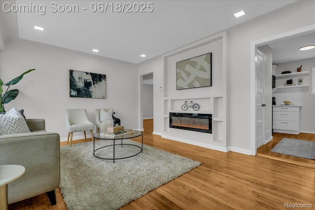 19505 Santa Barbara Dr, Detroit, MI 48221 - living area featuring built in features, wood finished floors, recessed lighting, and a glass covered fireplace