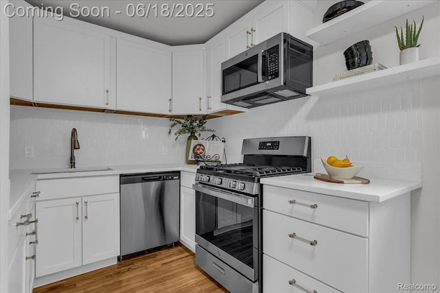 19505 Santa Barbara Dr, Detroit, MI 48221 - kitchen with stainless steel appliances, open shelves, backsplash, and white cabinetry