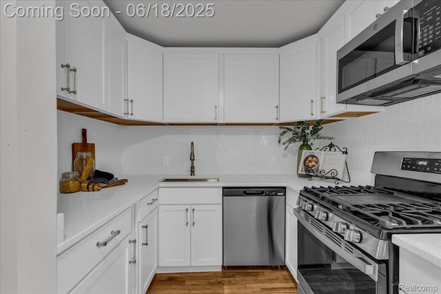 19505 Santa Barbara Dr, Detroit, MI 48221 - kitchen with appliances with stainless steel finishes, light countertops, white cabinetry, and tasteful backsplash
