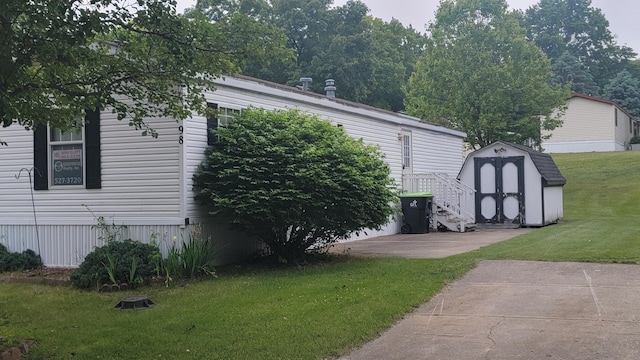1133 Yeomans St Unit 98, Ionia, MI 48846 - view of grassy yard with a storage unit