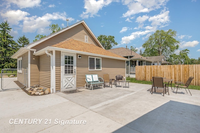 2942 Harrison St, Saginaw, MI 48604 - back of property featuring a patio area and roof with shingles