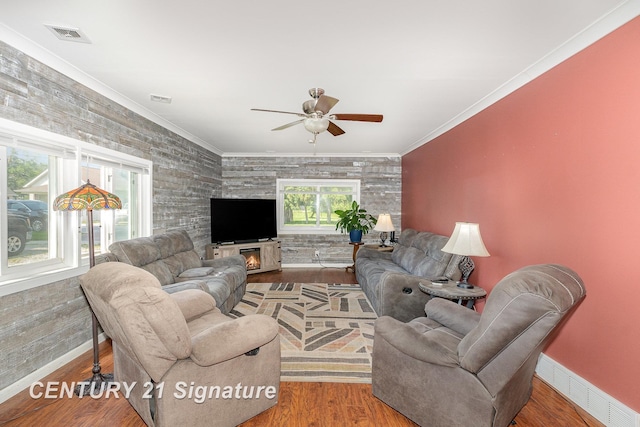 2942 Harrison St, Saginaw, MI 48604 - living room with a ceiling fan, wood finished floors, an accent wall, and ornamental molding