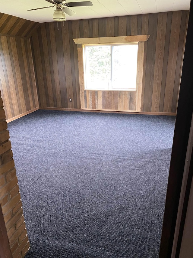 4441 Deckerville Rd, Lupton, MI 48635 - carpeted spare room featuring a ceiling fan and wooden walls