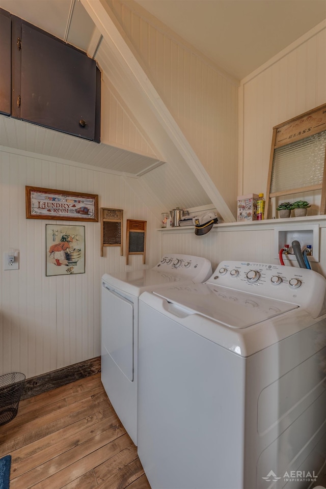4441 Deckerville Rd, Lupton, MI 48635 - laundry area featuring washing machine and clothes dryer, wood finished floors, cabinet space, and wood walls