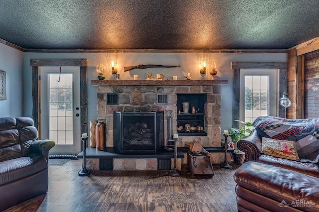 4441 Deckerville Rd, Lupton, MI 48635 - living area with a fireplace, crown molding, plenty of natural light, wood finished floors, and a textured ceiling