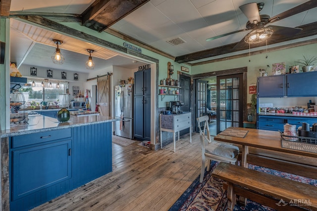 4441 Deckerville Rd, Lupton, MI 48635 - kitchen with appliances with stainless steel finishes, blue cabinetry, ceiling fan, wood-type flooring, and beam ceiling