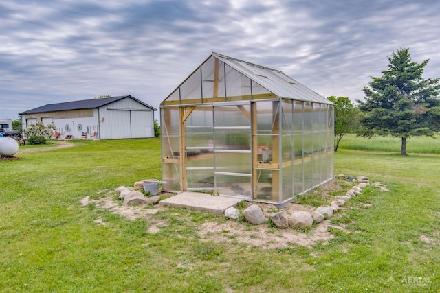 4441 Deckerville Rd, Lupton, MI 48635 - view of greenhouse featuring a lawn