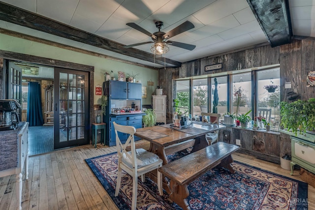 4441 Deckerville Rd, Lupton, MI 48635 - dining area featuring french doors, wooden walls, light wood-style flooring, and ceiling fan